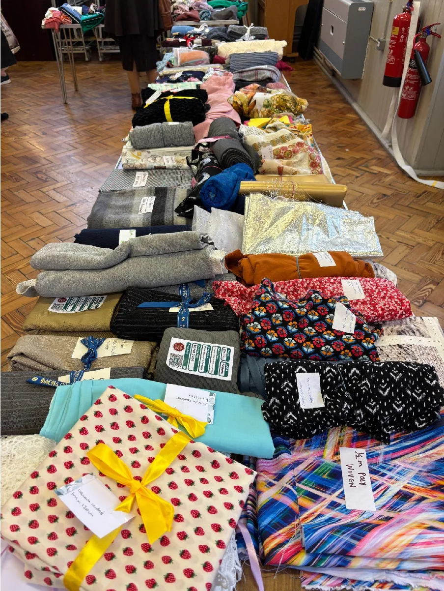 Labelled fabrics tied into neat bundles on a sewing swap table at the Surrey Sews November 2024 swap
