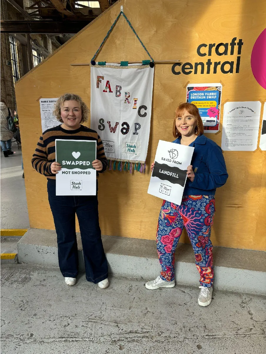 Yvette and Mel holding Swapped Not Shopped and Saved From Landfill signs at the London Destash Fabric Swap with Olive Road London